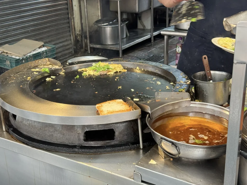 天天利美食坊的店門口正在煎蚵仔煎。