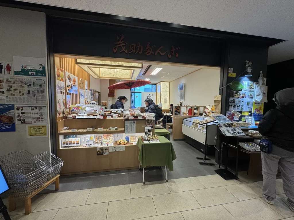 豐洲市場內茂助だんご店面外觀,販售團子與日式點心,櫃台前陳列多種和菓子。