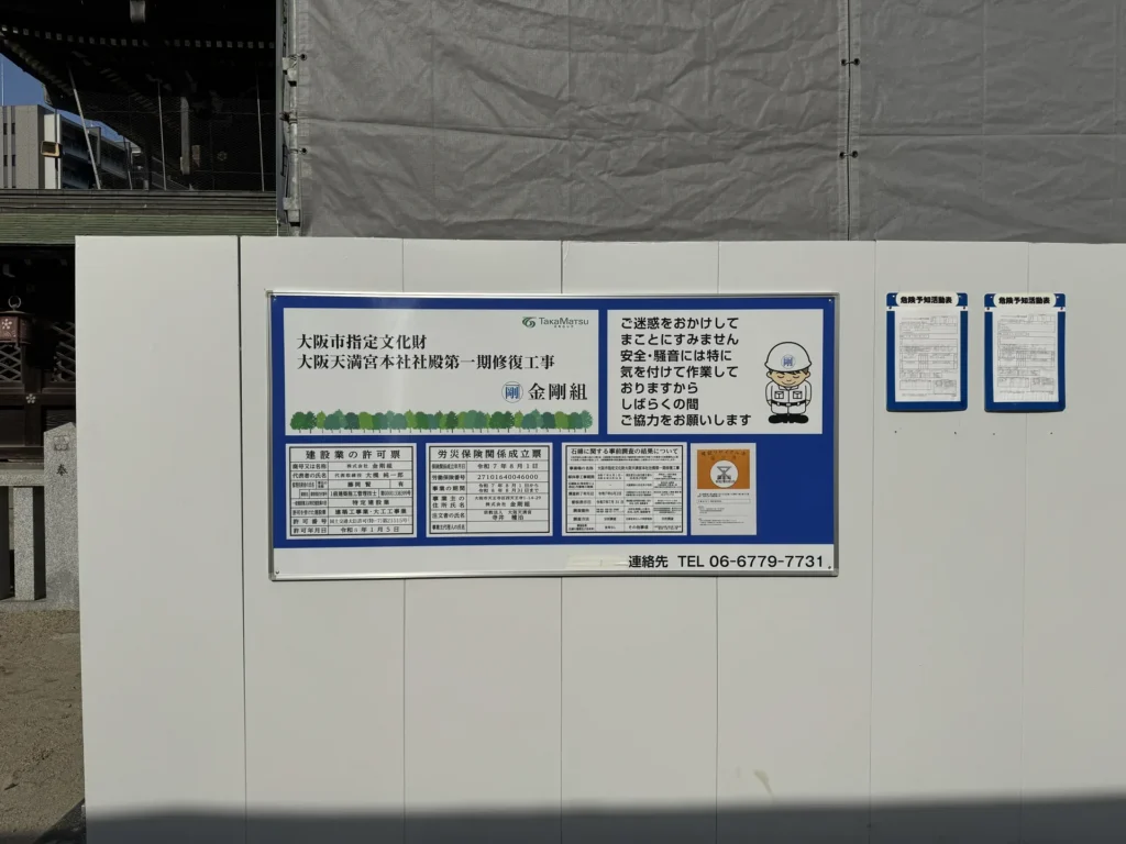 大阪天滿宮的工程看板,寫著大阪市指定文化財、大阪天満宮本社社殿第一期修復工事和金剛組