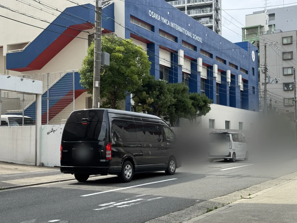Osaka YMCA International School 的藍色校舍，外牆寫著校名