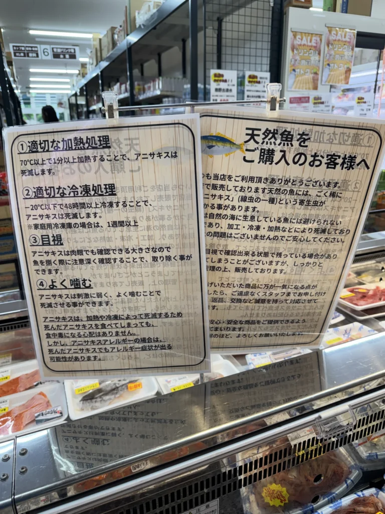 業務用超市海鮮櫃上的說明牌，寫著購買天然魚的注意事項