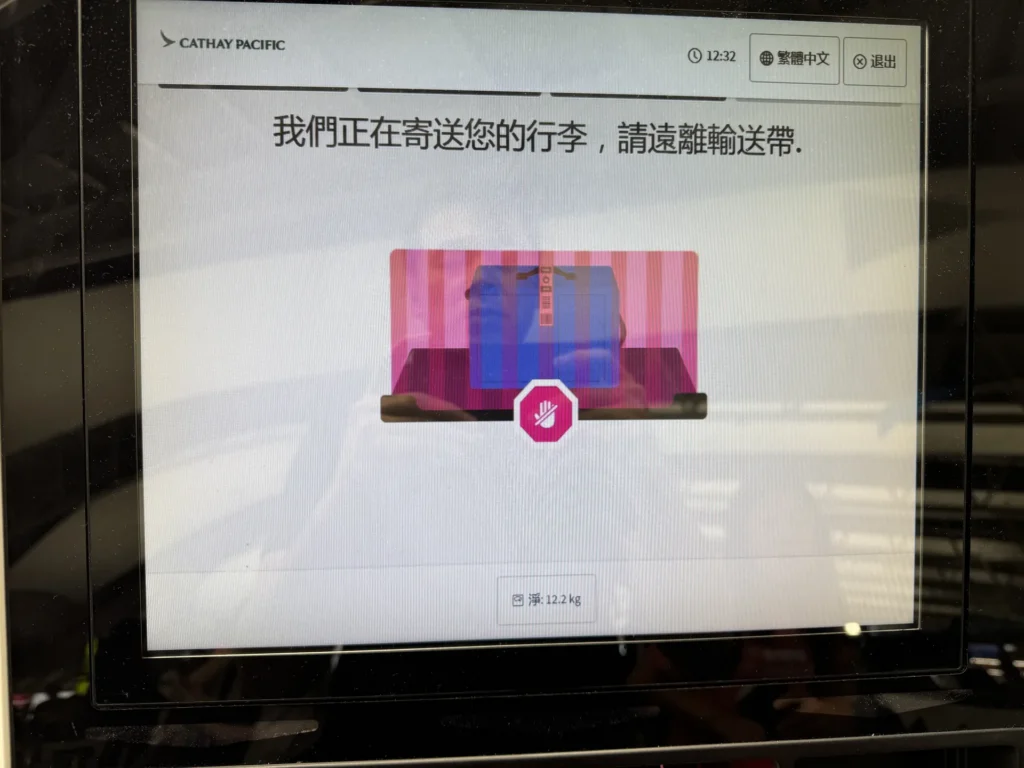 自助托運機的螢幕，寫著正在寄送您的行李